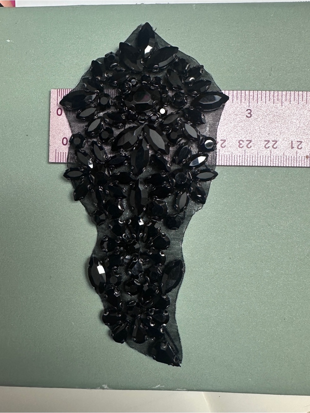 One black glass rhinestone ornamental appliqué